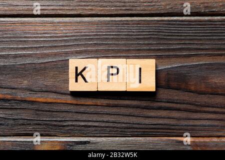 kpi word written on wood block. kpi text on table, concept. Stock Photo
