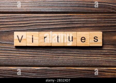 virtues word written on wood block. virtues text on wooden table for your desing, concept. Stock Photo