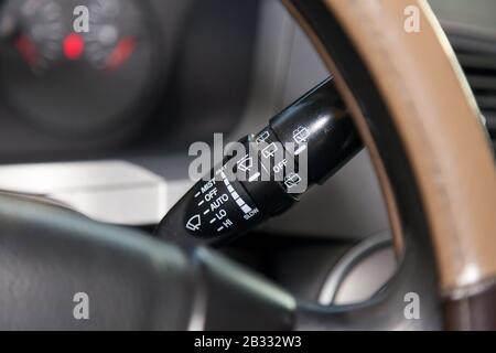 Wiper mode selection button with automatic adjustment through the rain sensor on the steering column of the car. The choice of weather. Stock Photo