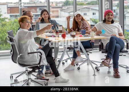 Group Of Asian and Multiethnic Business people with casual suit working with happy action in the modern workplace, people business group concept Stock Photo