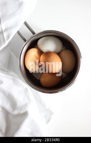 Overhead View of Eggs in a Pan. Colorful Hen's Eggs Cooking. Stock Photo
