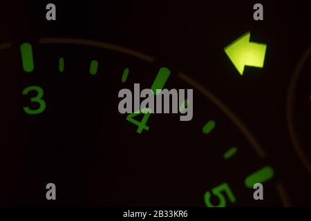 Close up shot of the turn signal icon displayed on a car dashboard. Stock Photo