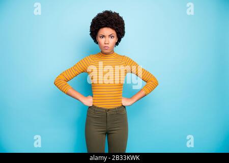 Photo of pretty dark skin wavy lady hold hands by sides angry with boyfriend action scolding him conflict wear yellow striped jumper trousers isolated Stock Photo