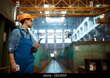 Master looks at work of crane operator on factory Stock Photo