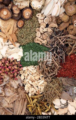 Chinese herbs used in traditional ancient herbal medicine forming a background. Stock Photo