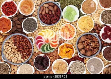 Dried fruit nuts and seed collection forming a background. Health food high in antioxidants, protein, omega 3. minerals, vitamins and anthocyanins. Stock Photo