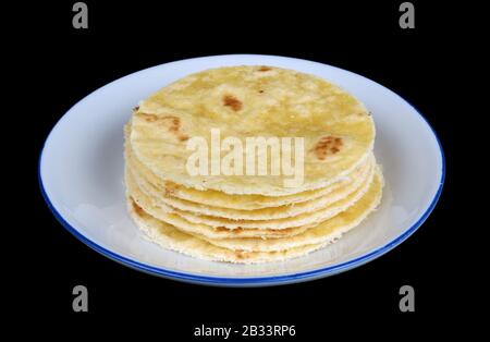 Nutritious handmade corn tortilla cooked on a metal griddle on a gas stove  in a Guatemalan home Stock Photo - Alamy