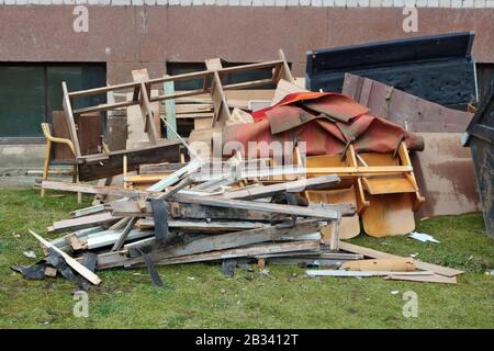 Odl carpets and broken  chairs and furniture at the garbage dump near the  apartment   building Stock Photo