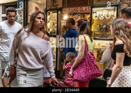 Tourists walking past Murano glass shop, Venice, italy Stock Photo