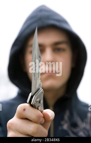 Youth with knife UK. Posed by model Stock Photo