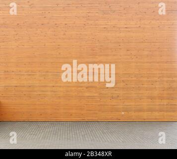 Wellow wooden wall from horizontal planks and  yard from concrete tiles  panorama. Natural colors simplistic  image Stock Photo