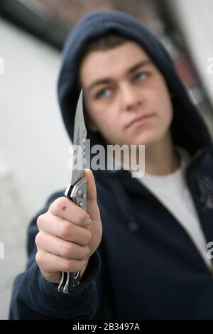 Youth with knife UK. Posed by model Stock Photo