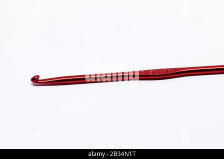 a red crochet hook on white background Stock Photo