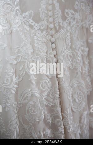 Close up of wedding dress on the brides wedding day, close up of white lacey wedding dress Stock Photo