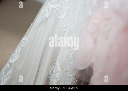 Close up of wedding dress on the brides wedding day, close up of white lacey wedding dress Stock Photo