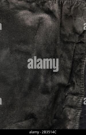 black structural background - old shabby stylish suede, reverse side, old fabric, textile. Stock Photo