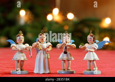 Four Christmas Angels Making Music: four decoration angels making music in front of Bokeh Christmassy lights Stock Photo