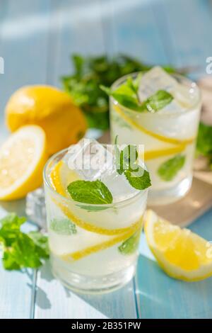Lemonade and ingredients on blue wood background Stock Photo