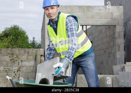 bricklayer builder working with autoclaved aerated concrete blocks Stock Photo