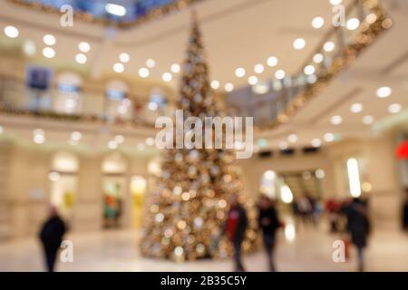 Customers in Christmassy Shopping Mall in Front of Christmas Tree Stock Photo