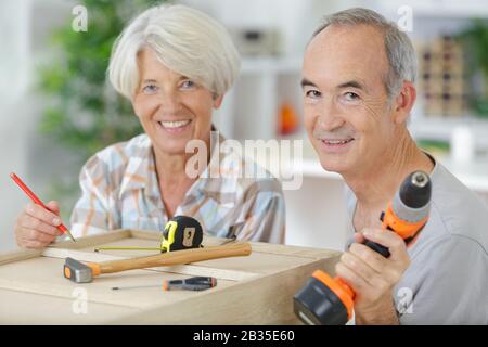 a senior couple doing diy Stock Photo
