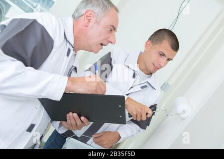 two builders making finish in the apartment Stock Photo