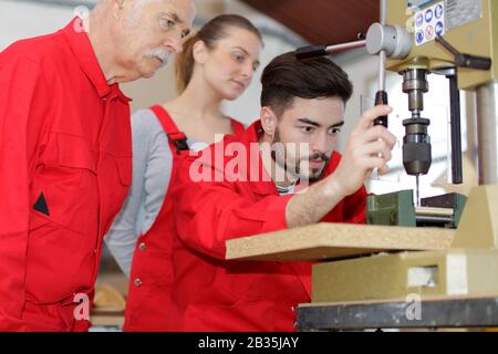 young man using drill machine Stock Photo