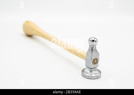 Closeup of a chasing hammer lying on a white background Stock Photo