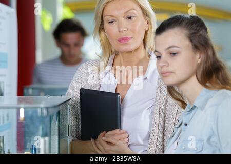 student showing something to her teacher Stock Photo