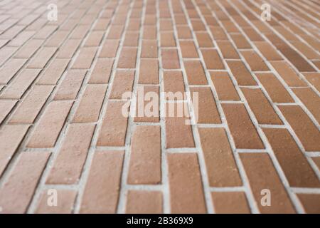 A brown ceramic brick wall with leakage point and selective focus, for background or building material resource Stock Photo