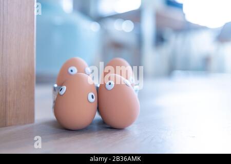 A group of Easter eggs with funny eyes is hidden early in the morning, children have to look for them. Happy Easter concept, Easter theme, background, Stock Photo