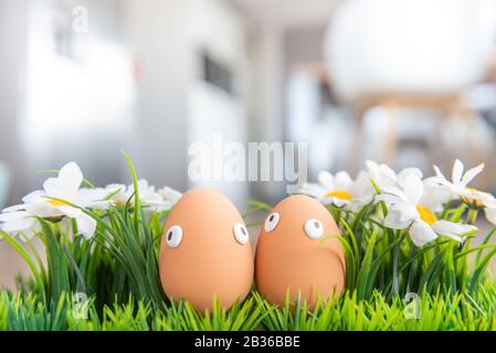 Easter eggs with funny eyes are hidden in the living room, children have to look for them. Happy Easter concept, Easter theme, background, postcard, s Stock Photo