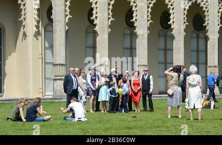 Group of guests and wedding party posing for photos for a wedding photographer at a wedding in England, UK. Stock Photo