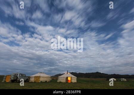 Mongolia, Omnogovi province, near Dalanzadgad, stars and clouds over a yurt camp at night Stock Photo