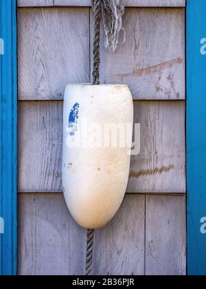 white fishing cork float hanging on wall Stock Photo