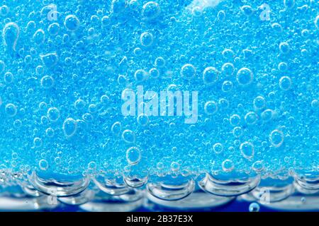 blue background is a sponge for washing dishes. bubbles, under water. porous macro sponge Stock Photo