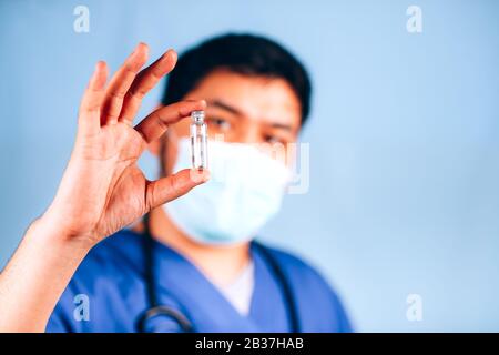 the doctor holds a test tube with medicine Stock Photo
