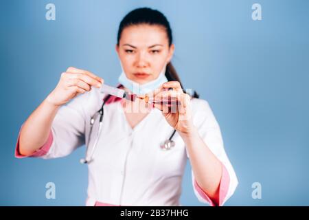 young girl doctor with a syringe in hand Stock Photo