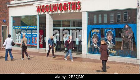 Archival Woolworths Group high street retail store chain business shop front Harry Potter  window adverts & shoppers in Chelmsford Essex England UK Stock Photo