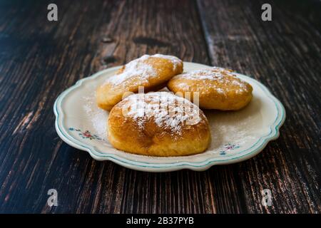 Mandazi is a slightly sweet East African Street Food; spicy, airy yeast doughnut dough made with coconut milk, flavored with cardamom and grated fresh Stock Photo