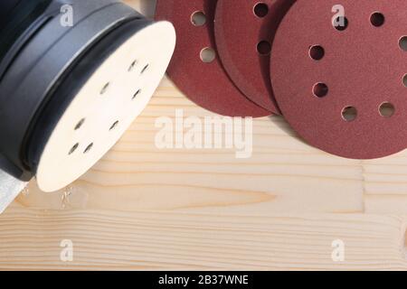 Carpentry. Wood sanding. Orbital sander for woodworking. In a natural light Stock Photo