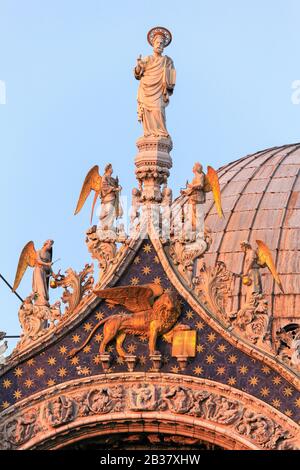 The winged lion of Saint Mark and Angels on Basilica di San Marco, Venice, Veneto, Italy. Stock Photo