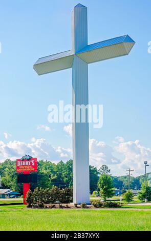 A 110-foot, 16-ton white cross stands outside Berry’s Seafood and Catfish House, Aug. 20,  2019, in Florence, Mississippi. Stock Photo