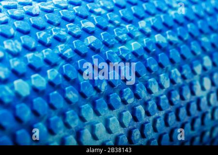 Abstract texture of a blue massage roller in the form of blue hexagonal cells. The entire screen as the background. Conceptual texture in the form of Stock Photo