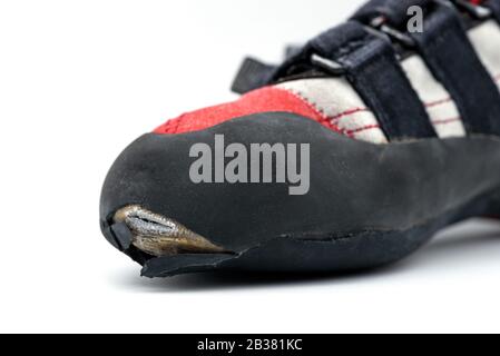 Worn climbing shoe requiring a full upper rubber replacement, isolated on white background. Stock Photo