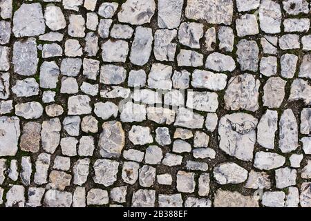 Stone pavers of gray stones near the old castle. Full screen Stock Photo
