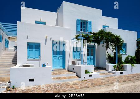 Traditional greek architecture houses painted white with blue doors and window shutters Stock Photo