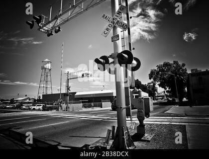 black and white view, classic image of road and railroad crossing point, small town of Patterson,California,USA Stock Photo