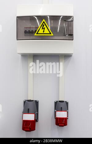 White Hinged Power Supply Box on the Wall Stock Photo