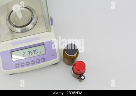 laboratory scale on table with materials in bottles. Stock Photo
